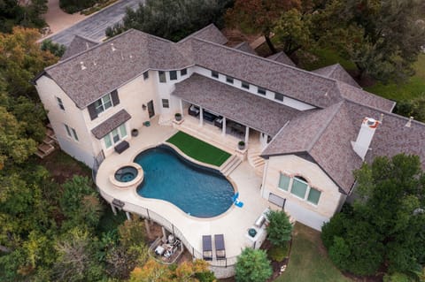 Aerial view of the home and pool yard nestled in the scenic Austin Hill Country.
