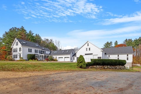 The full estate from the driveway — the apartment entrance is on the left side of the main house, with the historic barn just beyond.