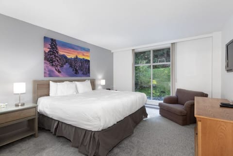 Unwind in crisp linens with peaceful garden-view windows.