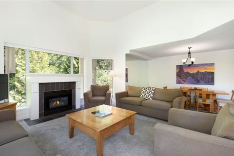 Gather by the fireplace in a bright, spacious living area.