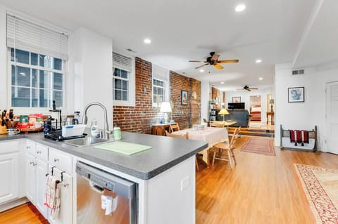 Kitchen & Living Area: Bright space with exposed brick, perfect for culinary adventures and relaxation!