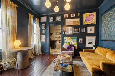 Kick back on the velvet sofa, enjoy a game at the table, and soak in the artistic charm of this cozy Savannah living room.