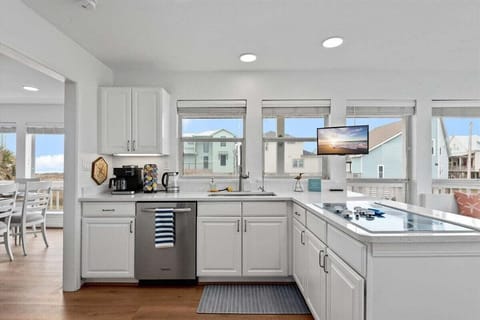 The fully equipped kitchen is adorned with stainless steel appliances and other comforts of home including a combo Keurig/Regular Coffee Maker with Keurig Pod Tower, Electric Hot Water Kettle, Instapot with Air Fryer, Blender, Waffle Maker, Electric