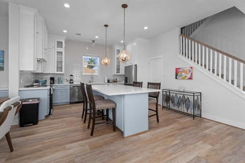 Modern kitchen with large island and seating, perfect for entertaining in Galveston beach vacation home.