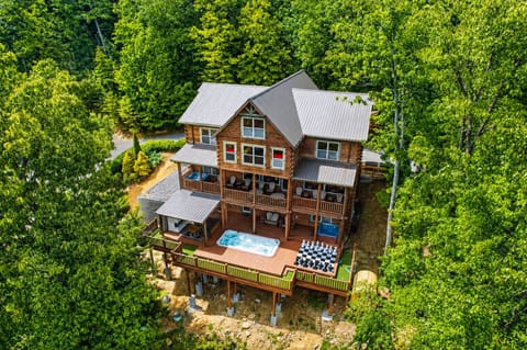 Exterior view of luxury Smoky Mountain MegaLodge featuring large mountain cabin architecture, spacious balconies, wooded surroundings, and scenic Tennessee views.