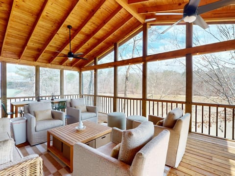 Screened Porch off upstairs living room with dining table.