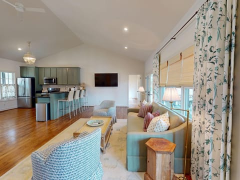 The living area features a 72" TV.