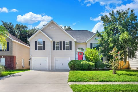 Charming home with a bright red door and great curb appeal.