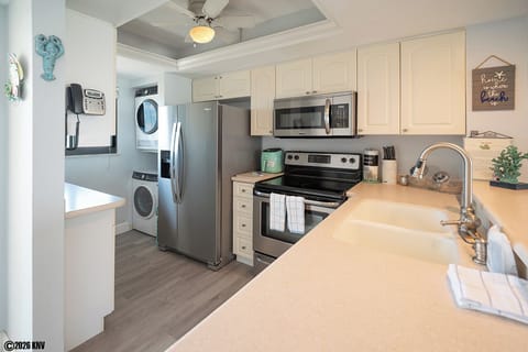 Newly remodeled Kitchen with new appliances including a dishwasher and a stackable washer and dryer