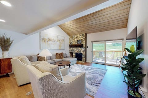 Living room with gas fireplace & deck overlooking 4th green of Elkhorn Golf Course.