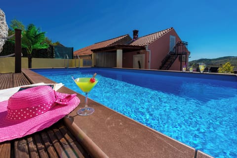 Bask in all-day sun by your private terrace pool, a sparkling blue oasis with panoramic views of the tranquil Croatian hills.