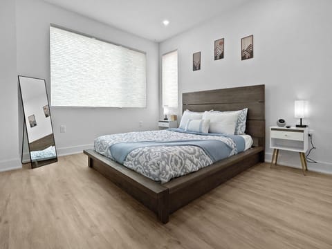 Drift into peaceful sleep in your serene bedroom, where soft blues and warm wood create the perfect retreat after busy travel days.