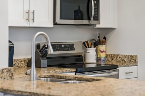 Your fully-equipped kitchen awaits with granite counters, stainless appliances, and everything you need to create delicious meals during your stay.