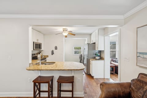 Your bright, open kitchen features granite countertops, stainless steel appliances, and a breakfast bar where you'll enjoy morning coffee together.