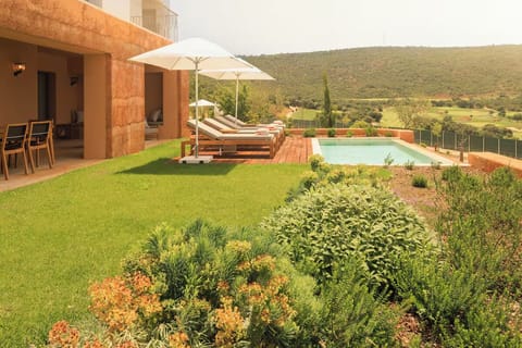 Step outside to manicured lawns, loungers, and serene valley views.