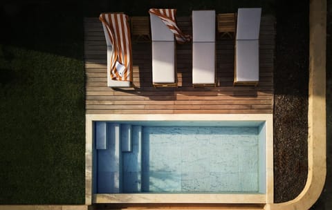 Unwind on chic loungers beside your private, sun-warmed pool.
