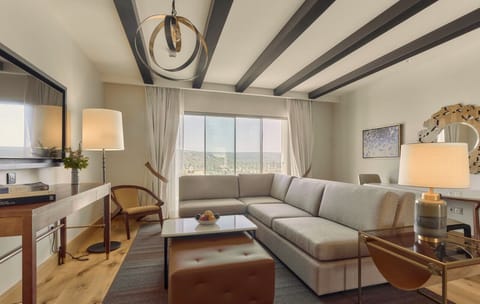 Lounge together in a sunlit living room with plush seating.