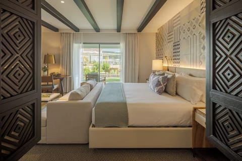 Relax in a spacious suite with cozy seating and soft linens.