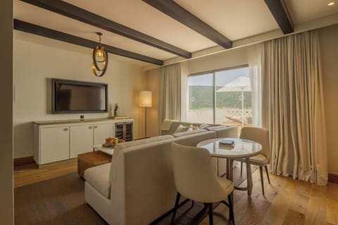 Unwind on the plush sofa with calming hillside views
