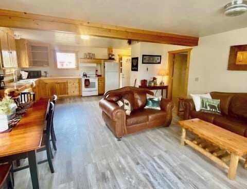 The living room with seating and tv for entertainment.