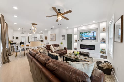 Welcome to your home away from home! Spacious open-concept living with plush leather seating, a cozy fireplace, and smart TV - all flowing into the dining and chef's kitchen. Perfect for movie nights or morning coffee.