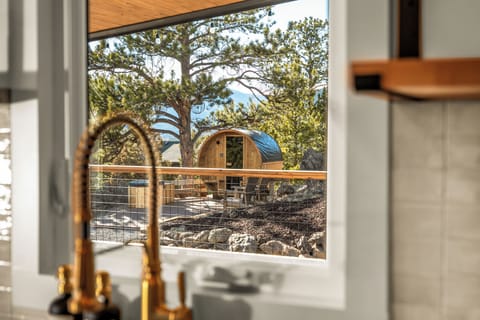 The Barrel Sauna and cold plunge are nestled into the rock formation - with a view from the house.