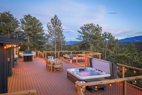 This patio/deck space is where you'll spend lots of time. Soaking in the hot tub, gathering around the dining table, and stargazing for hours