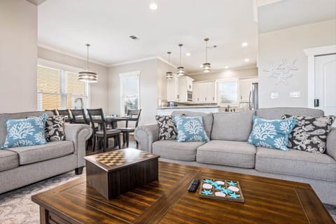 Relax in living space with plush sofas and open kitchen.
