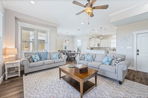 Spacious living area with plush sofas and coastal accents.