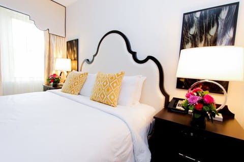 Drift off beneath a statement headboard and soft bedside glow.