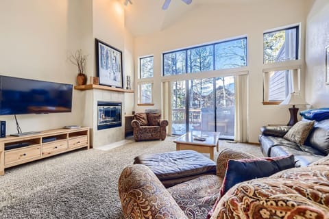 Unwind in this cozy living room where you'll love the crackling fireplace and mountain views through expansive windows.