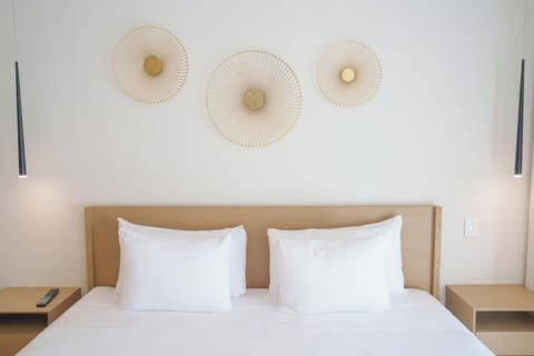 Sink into cloud-soft pillows beneath elegant, soothing wall décor.