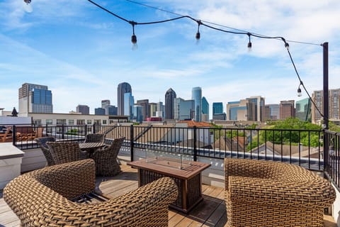 Cozy up by the fire pit while taking in the city lights on this stylish rooftop 