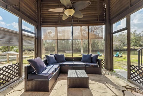 Private screened patio seating area overlooking the peaceful riverfront