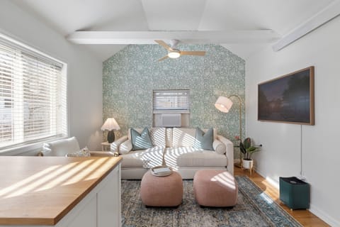 Welcome! Walk into an open, bright living room with sofa bed and 55" Canvas TV.