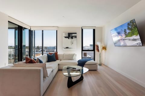 Sun-drenched luxury: A sleek, 65" Smart TV anchors this designer living space.