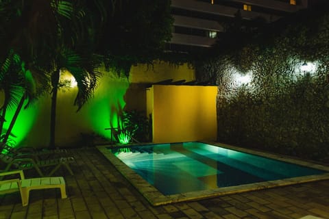 Soak in a moody evening dip with glowing garden lights.
