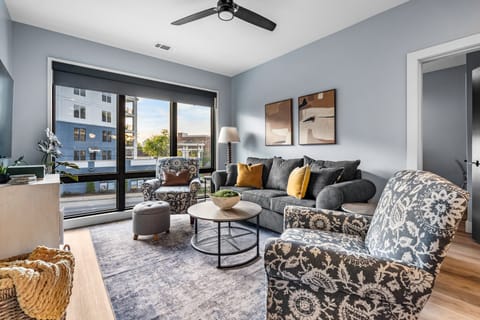 Ample seating in living area with an open concept floor plan leading you into the kitchen