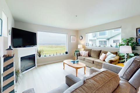 Living room with a 30in flat screen tv and a beautiful ocean view.