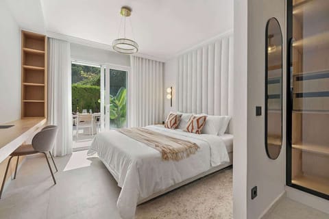 The master bedroom features a designated workspace, an en-suite bathroom, and a private walk-in closet.