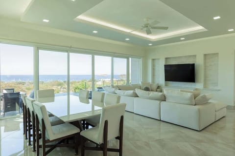 Open concept living room and dining room with ocean view