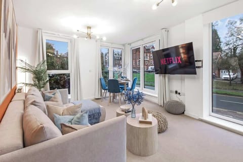 Bright Living & Dining Area: A spacious open-plan space with comfortable seating, Smart TV, and a dining table by the windows.
