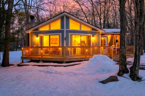 The glowing Chalet-style facade at dusk.