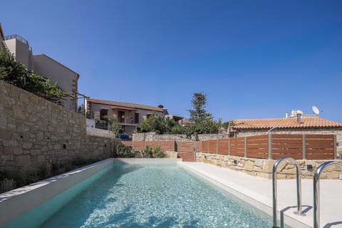 Main Building -  The pool area is equipped with 6 sun beds, side tables, a poolside shower, and 3 umbrellas