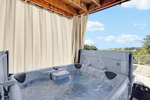 Soak in the hot tub while enjoying panoramic countryside views