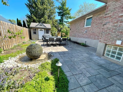 Beautiful backyard oasis with propane BBQ and outdoor table/seating. 
