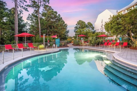 Unwind at the glowing pool, lounge chairs awaiting you.