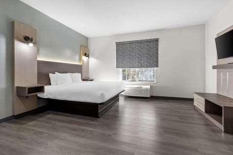 Unwind in a bright, modern room with plush bedding.