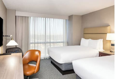 Wake up to natural light by the window and plush beds.