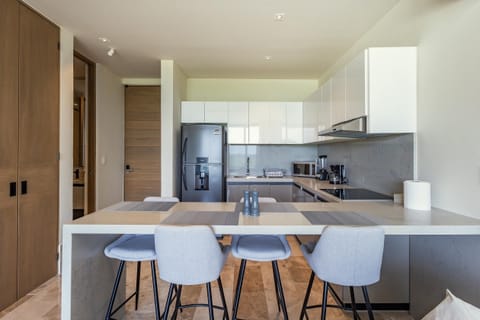 Modern kitchen with sleek appliances and cozy breakfast bar seating